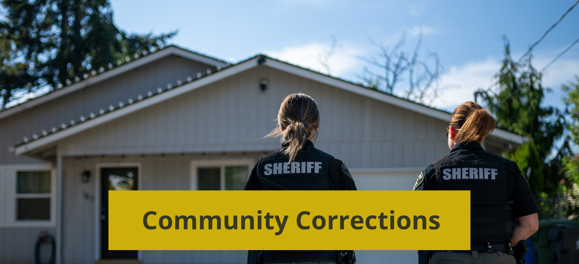 Two Community Corrections Officers on their way to check in on a client at their home.