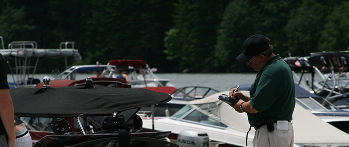 Doc Nelson performing a boat inspection at detroit lake